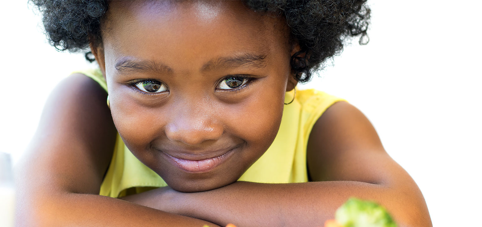girl smiling with plate of food