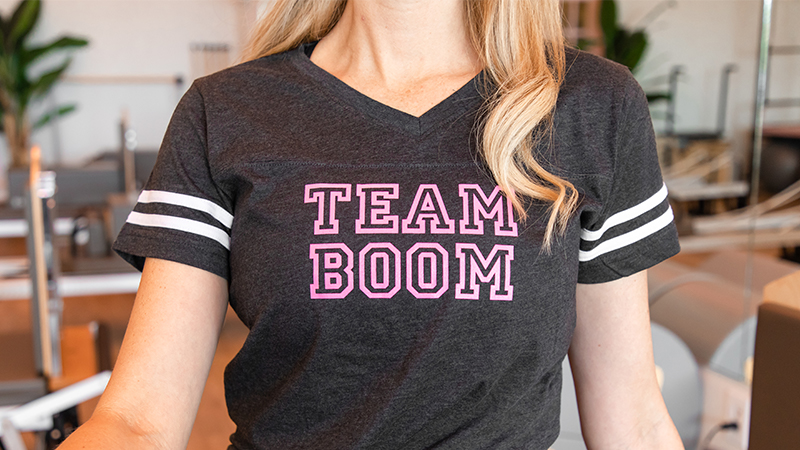 woman wearing boom pilates shirt