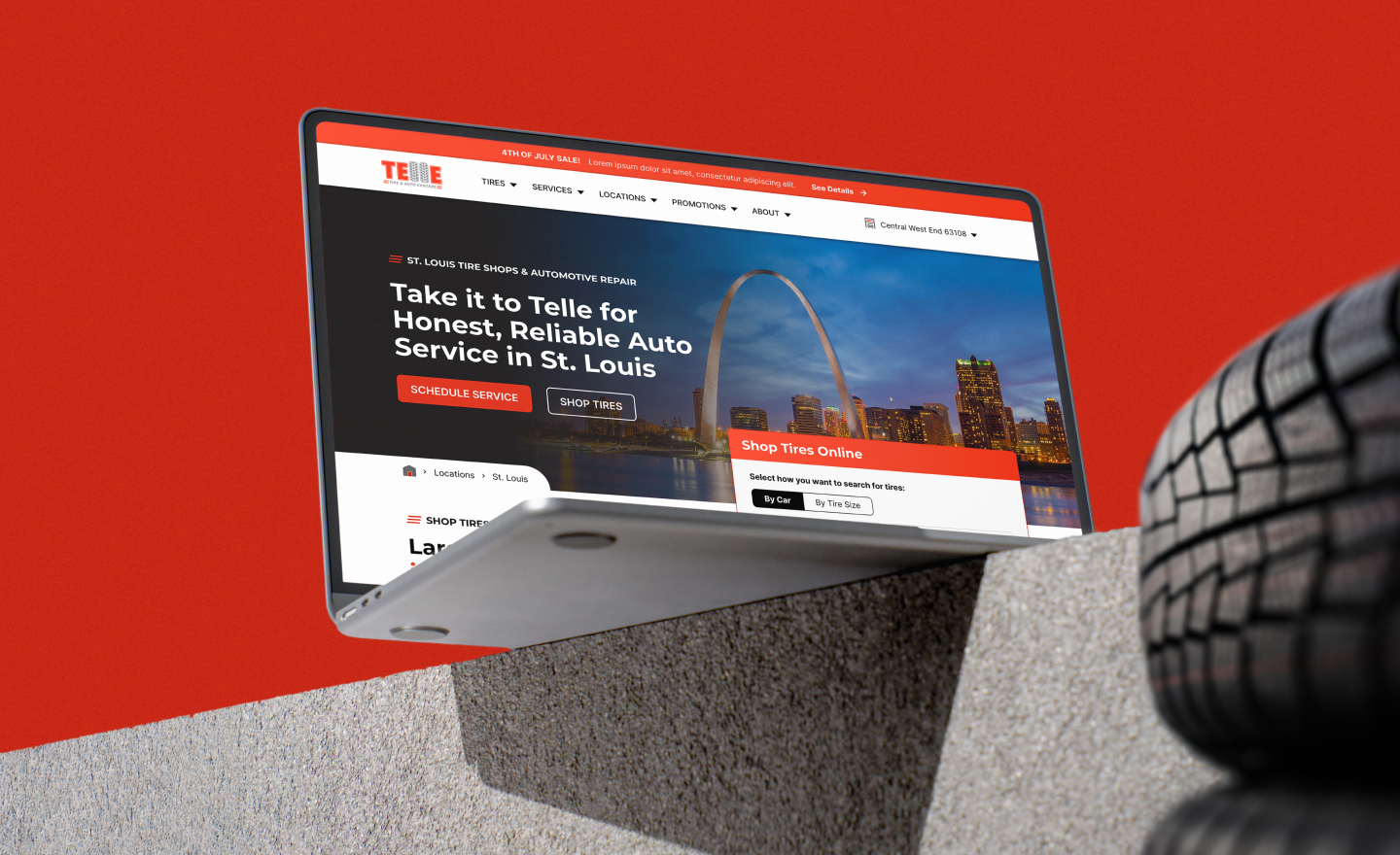 A laptop displays a website for Telle auto service with the St. Louis cityscape, including the Gateway Arch. The background is red, and a tire is in the foreground.